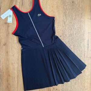 La Coste Navy tennis dress with pleats and red trim. Separate shorts included